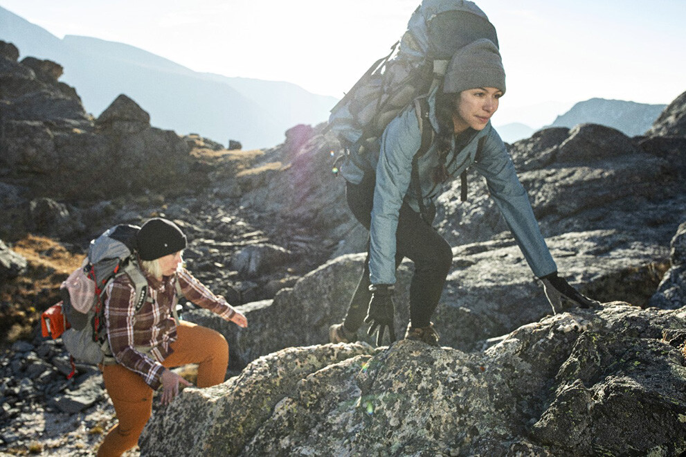 Backpackers ascending a rocky slope