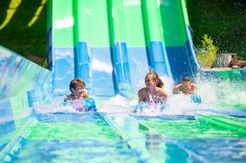 Family Racing Down Quadzilla Slide at Noahs Ark Waterpark in Wisconsin Dells