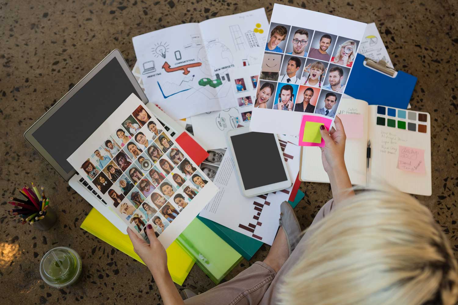 Businesswoman sitting on floor holding documents