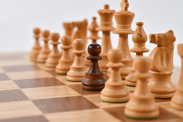 Wood chess pieces with a pawn of opposite color